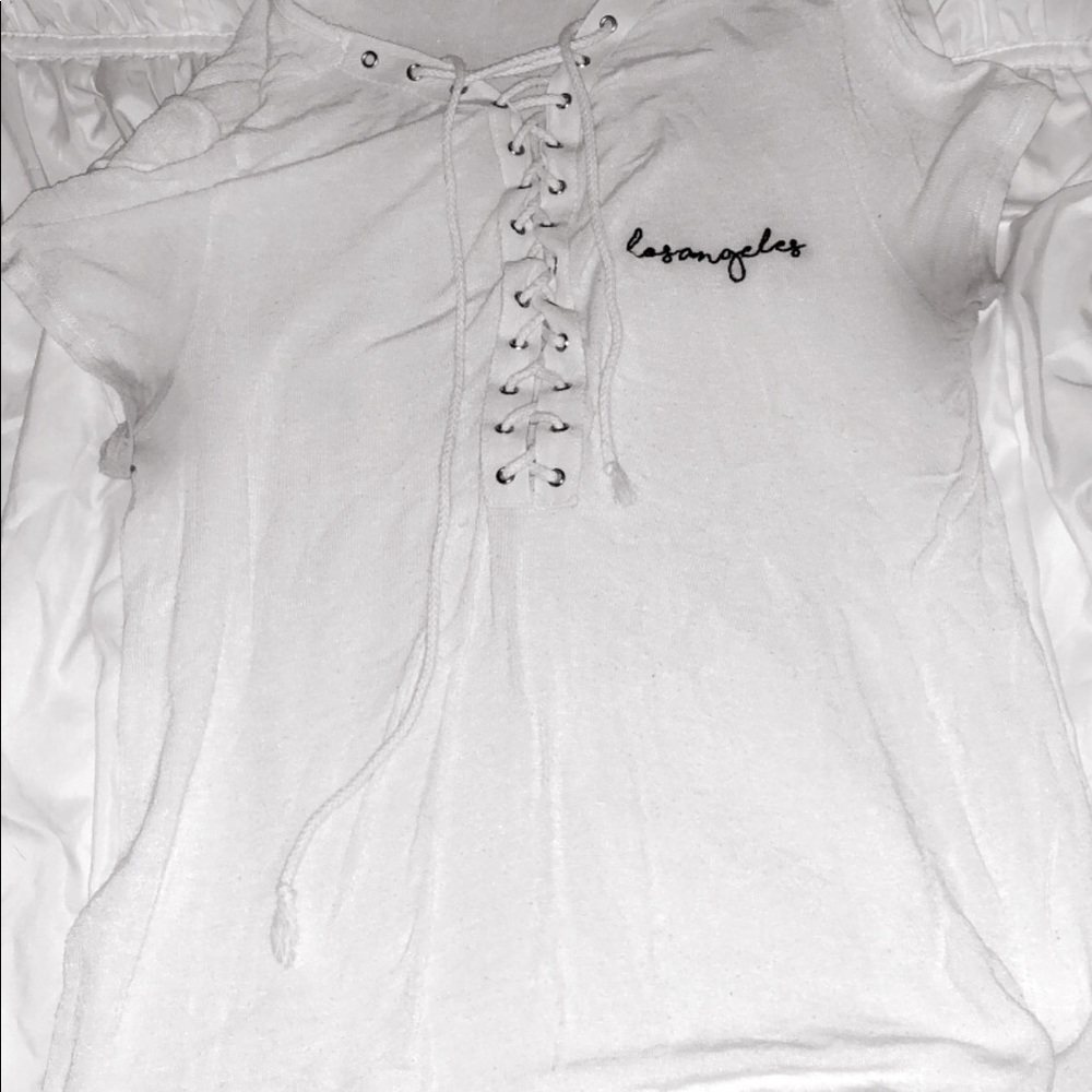 white criss cross shirt with saying “los angeles”